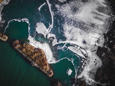 aerial photo of body of water and islet thumbnail