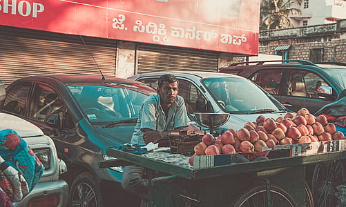 man sitting in front of fruits thumbnail