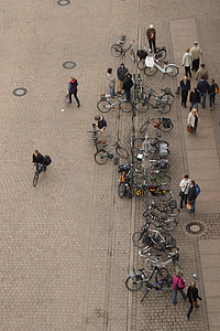 aerial photo of lots of people near bicycle parking area during day thumbnail