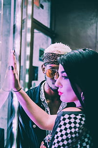woman facing on glass and man wearing black shirt facing on woman thumbnail