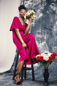 Woman in Pink Maxi Dress Holding Bouquet of Flowers thumbnail