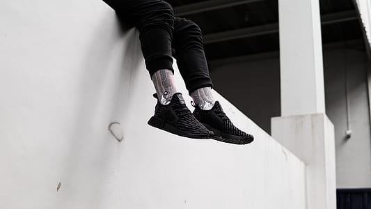 person wearing black adidas shoes thumbnail