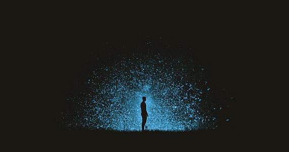 silhouette of man standing surrounded by blue lights in the dark thumbnail