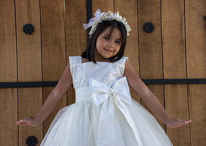 girl standing beside brown wall thumbnail