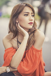 tilt-shift photography of woman with hands on neck thumbnail