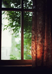 low-light photography of brown and white curtain and clear glass window pane thumbnail