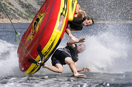 two men on inflatable boat on water thumbnail