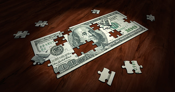 100 U.S. dollar bill puzzle on wooden surface thumbnail