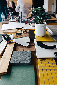 Designers working with material samples and paper cutouts thumbnail