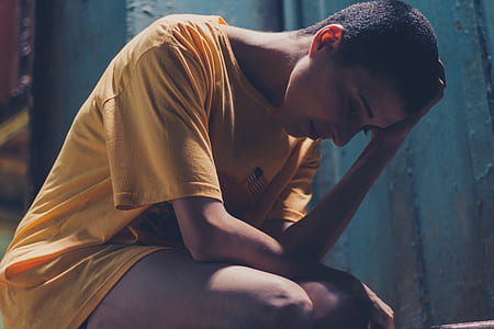 Woman In Yellow Shirt Resting Left Hand On Head thumbnail