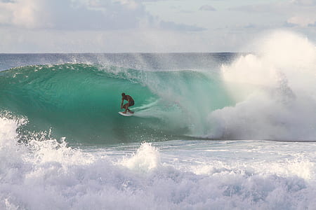 man riding surfboard on sea waves thumbnail