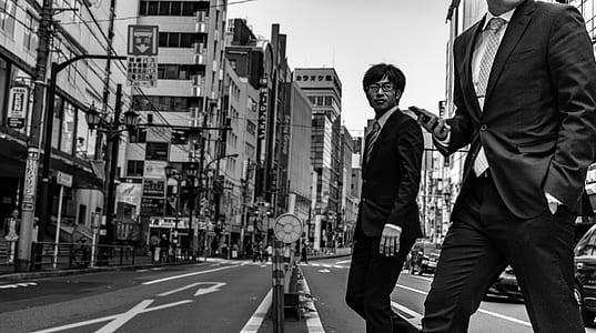 grayscale photography of people crossing street thumbnail