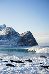 person surfing on waves under blue sky during daytime thumbnail