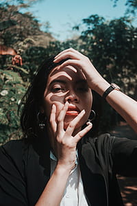 closeup photo of woman wearing black suit jacket covering herself with hands thumbnail