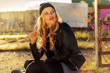 Woman Sitting Near Brown Wooden Plank thumbnail