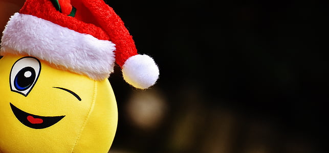 selective focus photo of yellow emoticon with Santa hat thumbnail