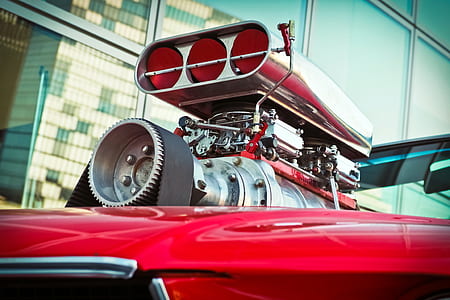 close-up photo of red vehicle with supercharger and intake manifold thumbnail
