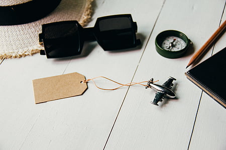 silver-colored airplane toy near the clock on gray panel thumbnail