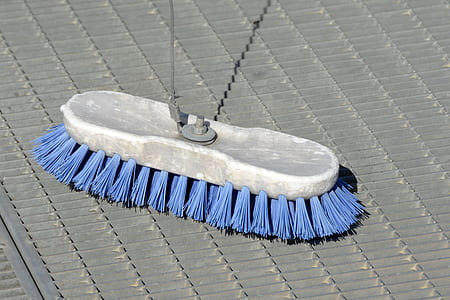 gray handled blue brush on gray surface thumbnail