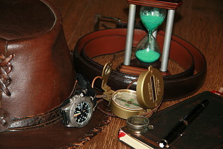 round gray analog watch with brown leather strap on brown leather hat thumbnail
