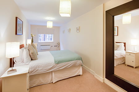close-up photo of bed beside wall thumbnail