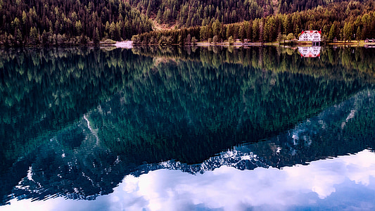 green mountain beside body of water thumbnail