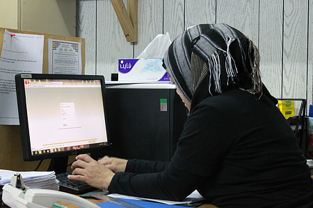 woman in black hijab using computer in office thumbnail