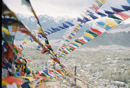assorted-color buntings on top of roof near mountain range covered with snow thumbnail
