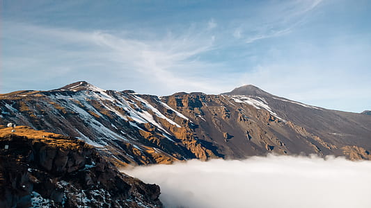 brown rock mountain over the clouds thumbnail