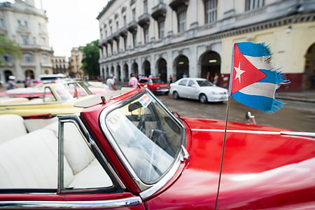 red convertible car with flag on the street thumbnail
