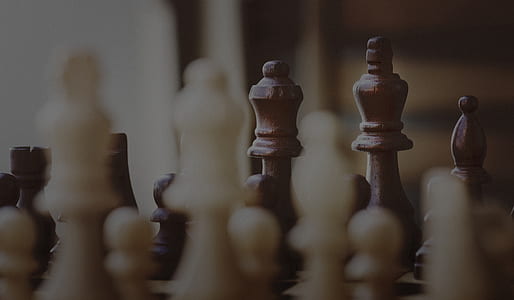 depth photography of white and brown chess pieces thumbnail