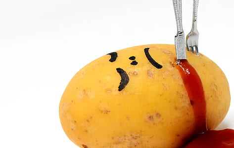 stabbed potato with knife and fork thumbnail
