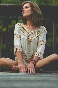 woman sitting on floor while leaning on brown wooden balustrade thumbnail