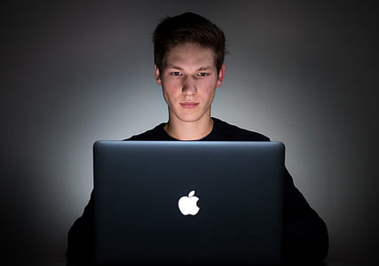 man in front of opened MacBook thumbnail