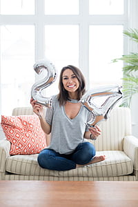 woman holding silver-colored 24 inflatable balloons thumbnail