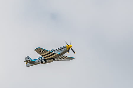 low-angle photo of bi-plane flying in sky at daytime thumbnail