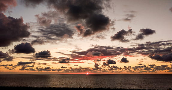 photo of ocean under cloudy sky thumbnail
