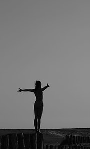 woman spreading her arms near beach thumbnail