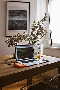MacBook Pro on table beside power bank and smartphone thumbnail