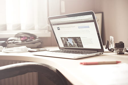 Black and Gray Laptop Computer on Writing Desk thumbnail