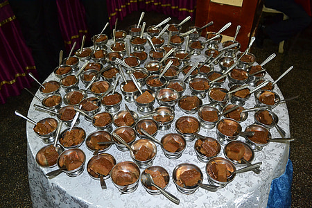 chocolates on silver bowls served on top of white table thumbnail