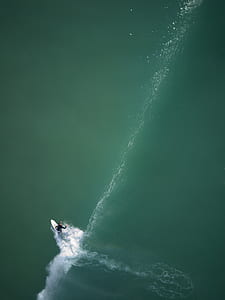high-angle view photo of person riding white surfboard thumbnail