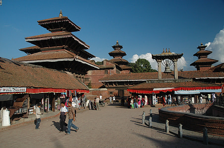 people walking and standing near building and temple during daytime thumbnail