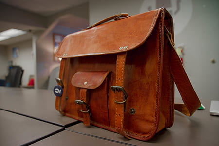 brown leather 2-way handbag on top white surface thumbnail