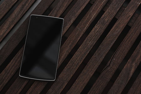 black Android smartphone on brown board thumbnail