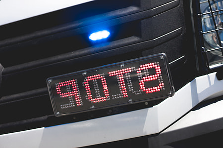 Police Flashing Light and STOP Sign on Car Mirrored thumbnail