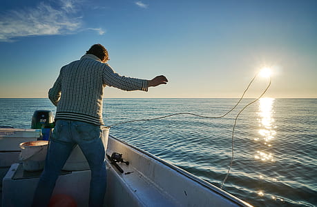 person standing on motorboat thumbnail