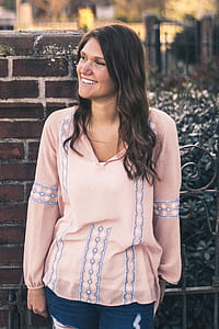 woman leaning of fence smiling thumbnail