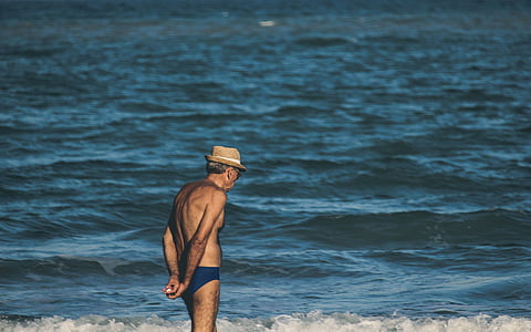man standing on shore during daytime thumbnail
