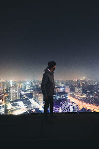 man standing on building roof top thumbnail